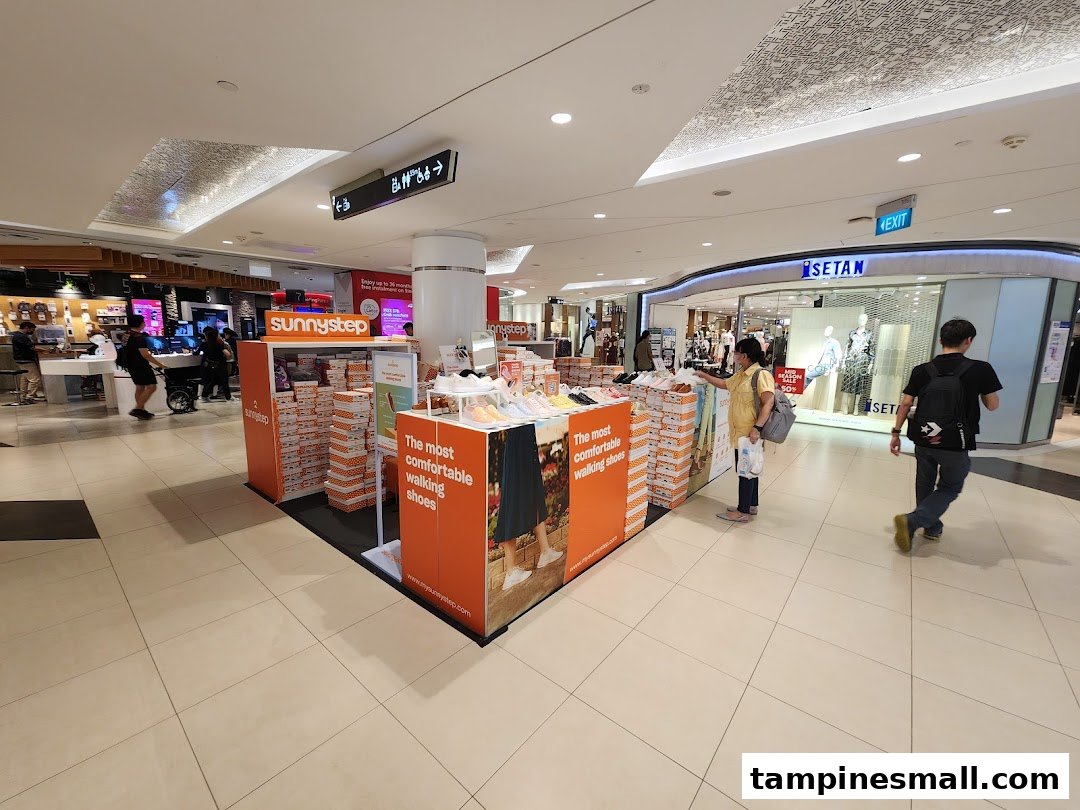 A Sunnystep kiosk in a shopping mall, showcasing comfortable walking shoes and shoe boxes.
