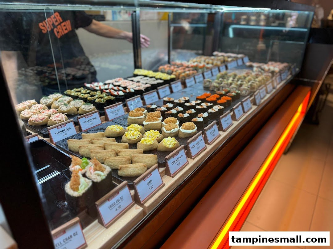 A vibrant display case showcasing a wide variety of fresh sushi and inari at Super Sushi.