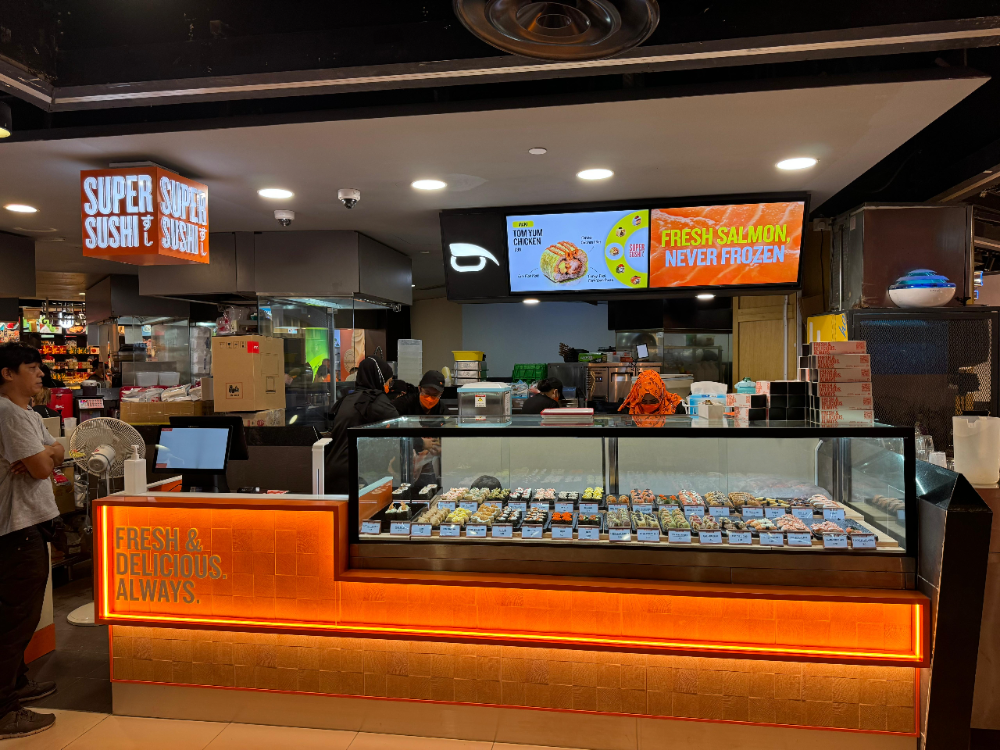 A vibrant sushi counter at Super Sushi, showcasing a wide array of fresh sushi and rolls.