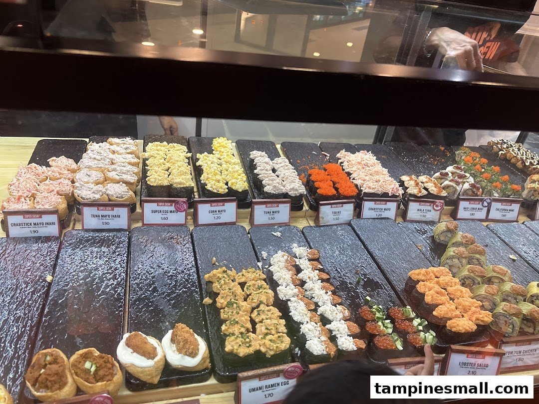 A vibrant display of various sushi and inari options with price tags at Super Sushi.