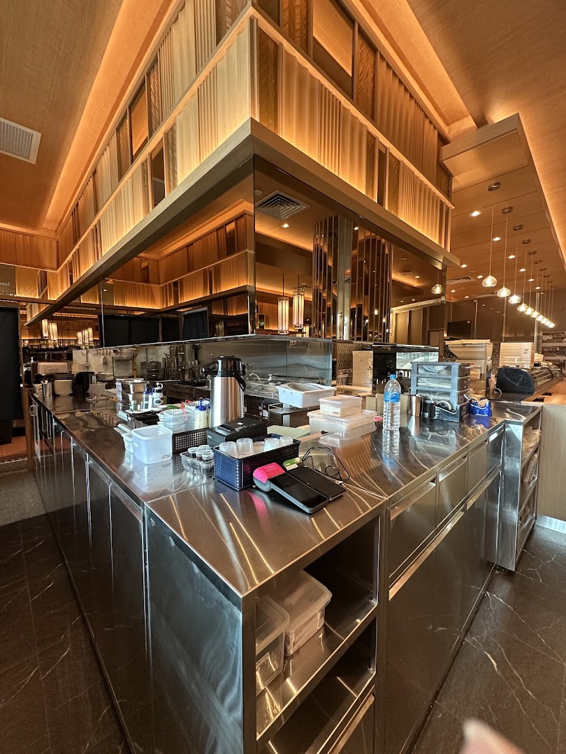 A clean, modern stainless steel counter area within Sushi Zanmai, showcasing the restaurant's operational space.