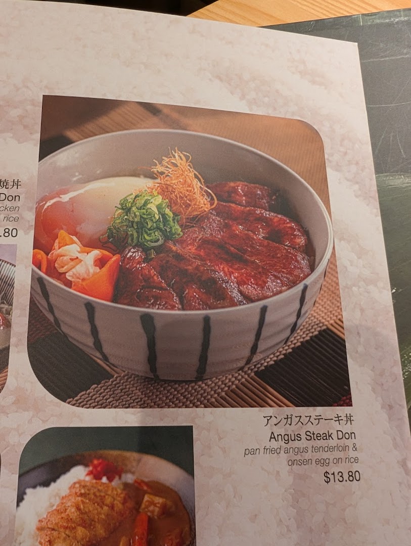 A menu page showcasing a delicious Angus Steak Donburi with an onsen egg.