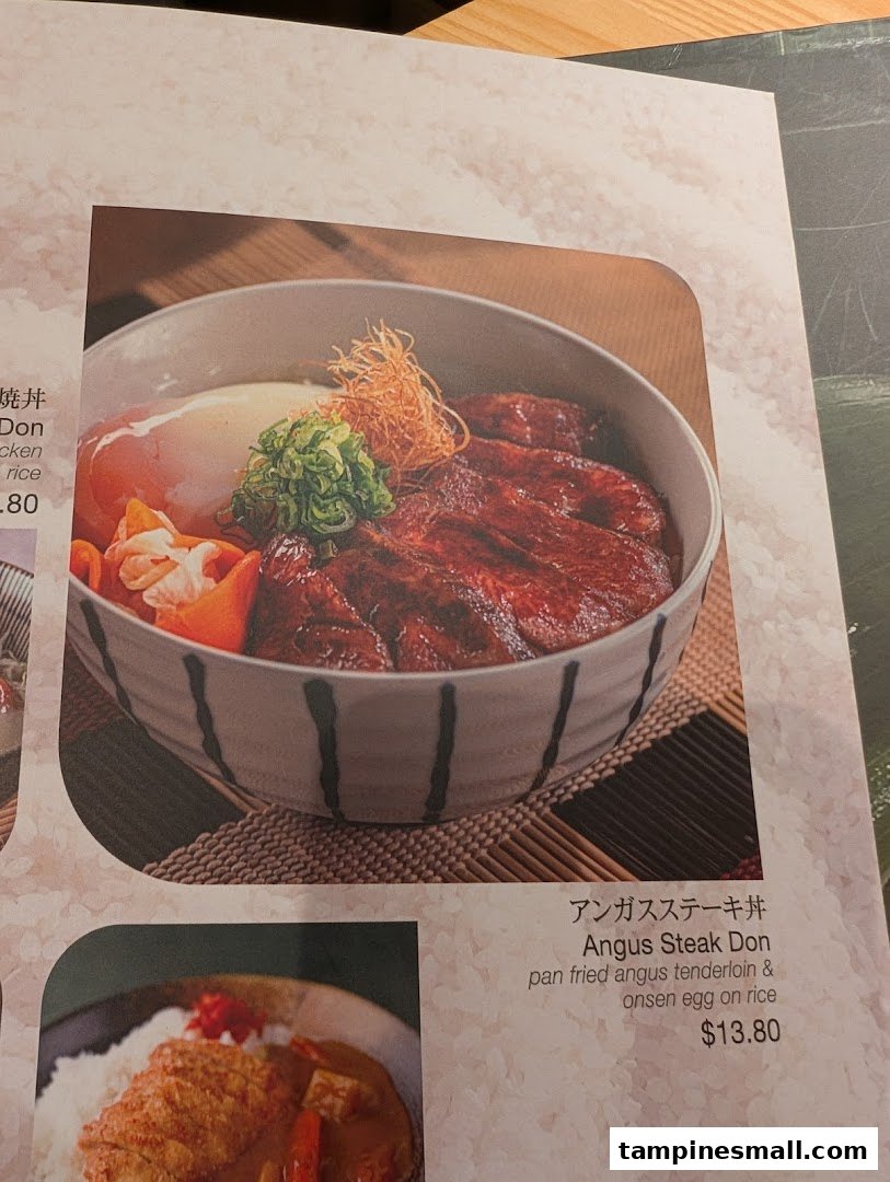 A menu page showcasing a delicious Angus Steak Donburi with an onsen egg.