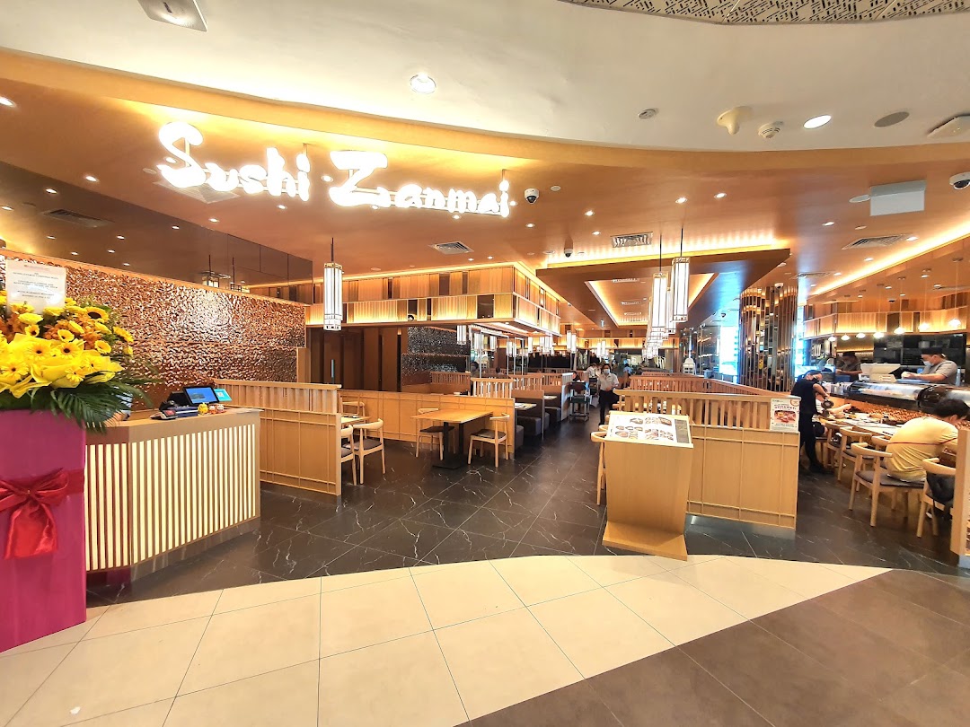 The inviting interior of Sushi Zanmai, featuring dining areas, a sushi counter, and a welcoming reception.