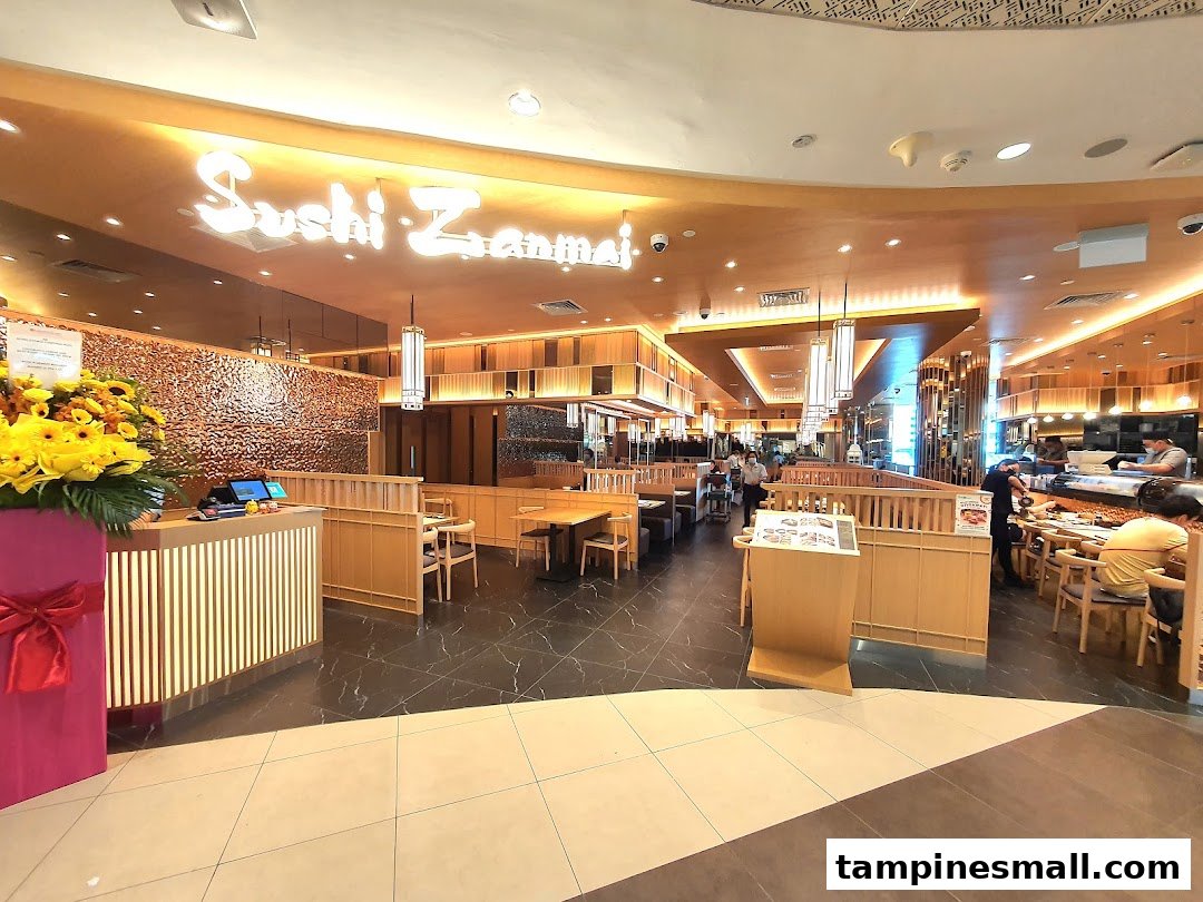 The inviting interior of Sushi Zanmai, featuring dining areas, a sushi counter, and a welcoming reception.