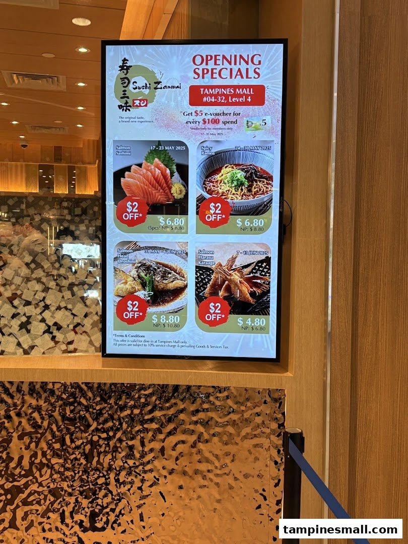 A digital display at Sushi Zanmai's entrance showcasing opening specials and discounted menu items.