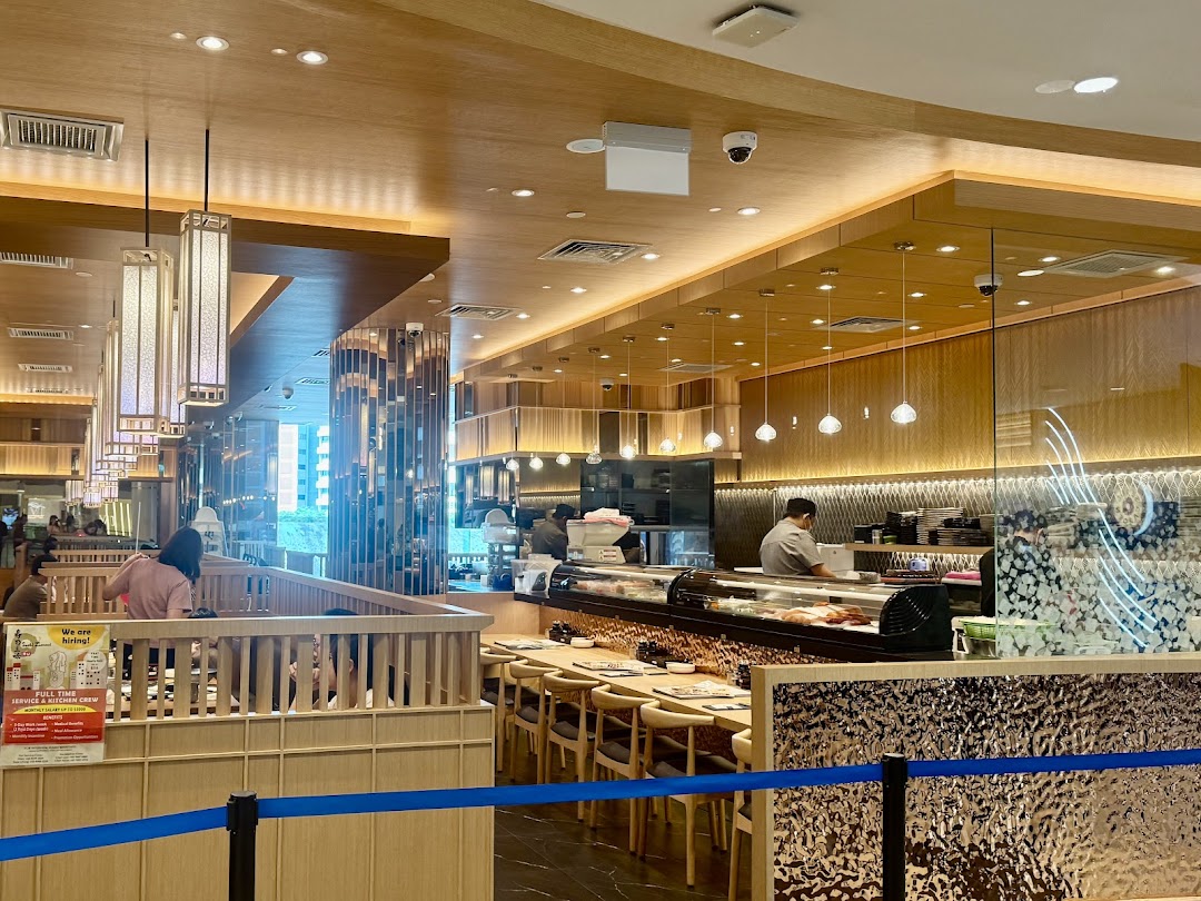 Interior view of Sushi Zanmai, showcasing its modern dining area and active sushi counter.