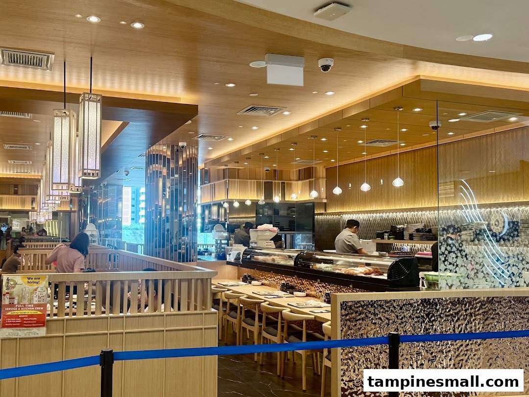 Interior view of Sushi Zanmai, showcasing its modern dining area and active sushi counter.
