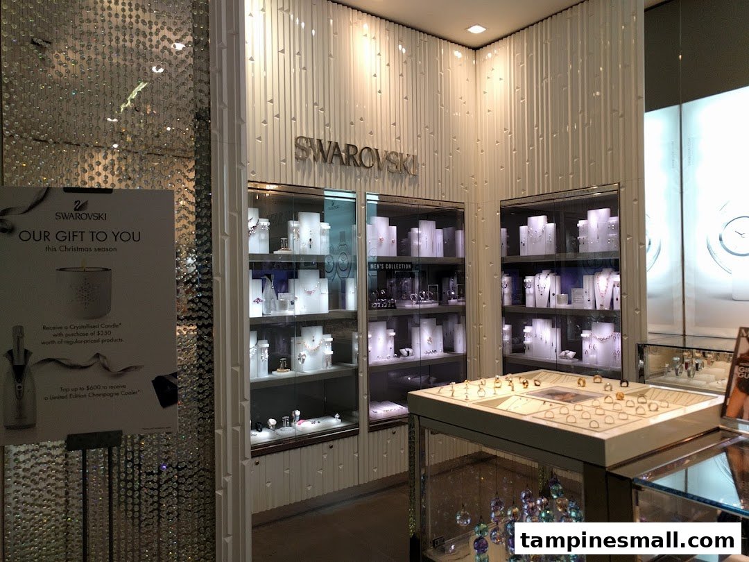 Interior view of Swarovski store showcasing sparkling crystal jewelry displays and a festive promotion.