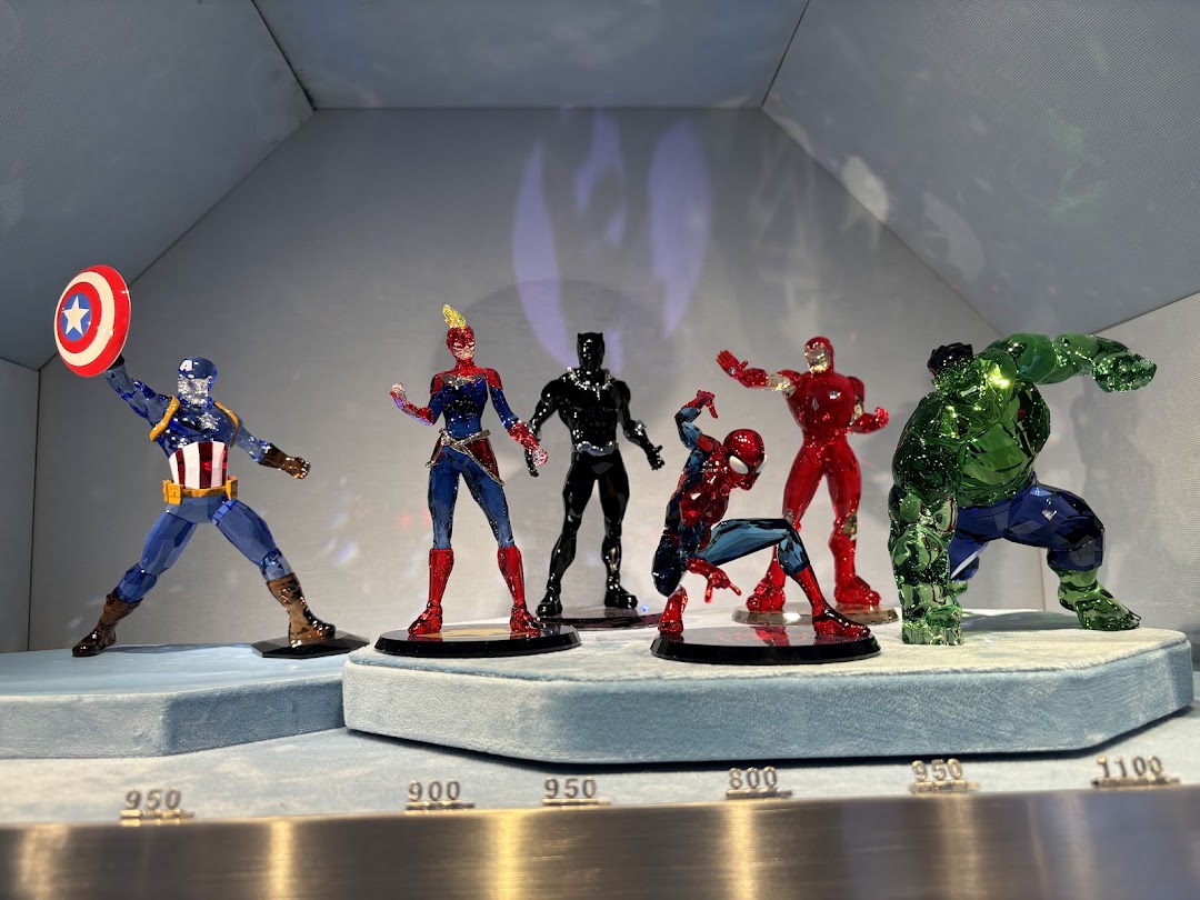 A display of Swarovski crystal Marvel superhero figurines, including Captain America, Hulk, and Spider-Man.