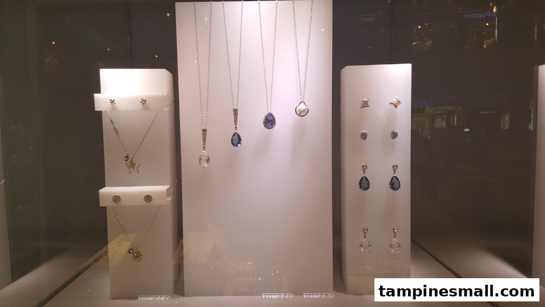 A close-up view of a Swarovski display case showcasing various necklaces and earrings with sparkling crystals.