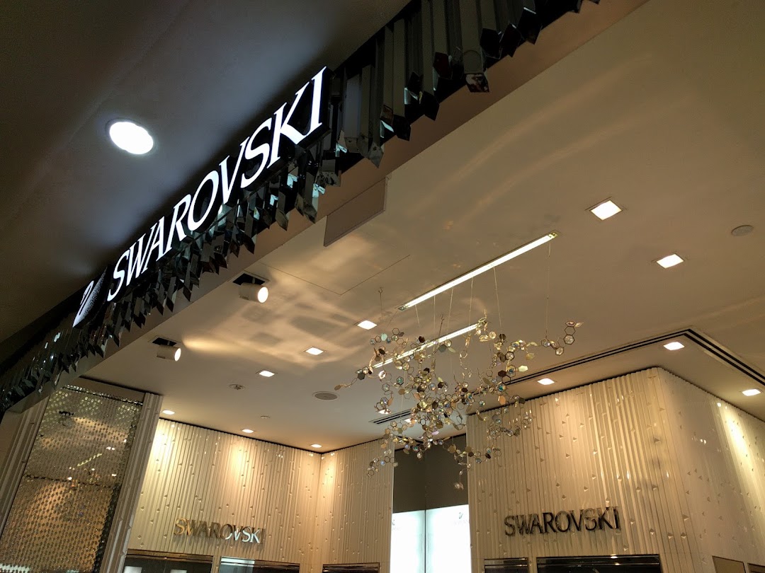 Illuminated Swarovski sign above the elegant entrance of the crystal store.