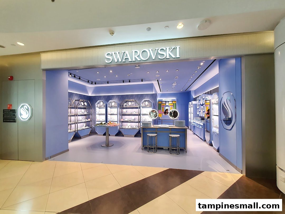 The elegant entrance of a Swarovski store showcasing its signature blue interior and sparkling displays.