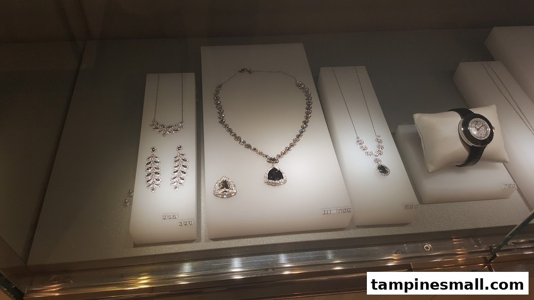 A display case showcasing sparkling Swarovski necklaces, earrings, and a watch, highlighting intricate crystal designs.