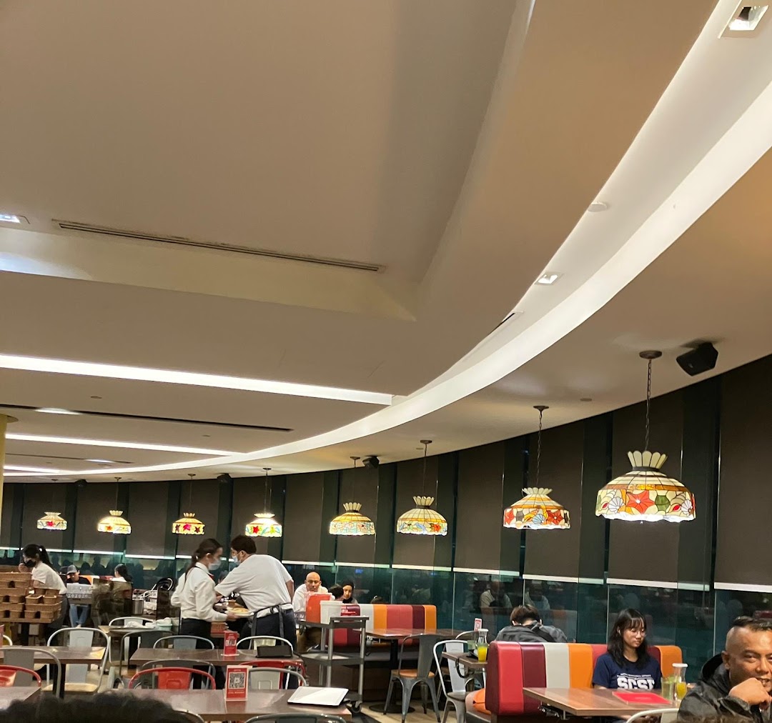 Interior view of Swensen's restaurant with customers dining and staff serving.