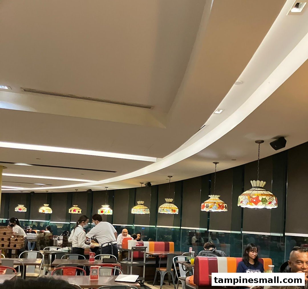 Interior view of Swensen's restaurant with customers dining and staff serving.