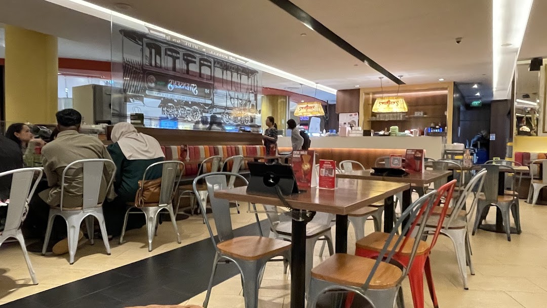 An inviting interior view of Swensen's restaurant with customers dining and comfortable seating.