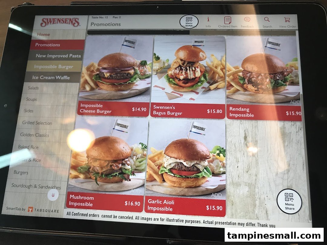 A digital menu display from Swensen's, showcasing various Impossible Burger promotions with prices and images.