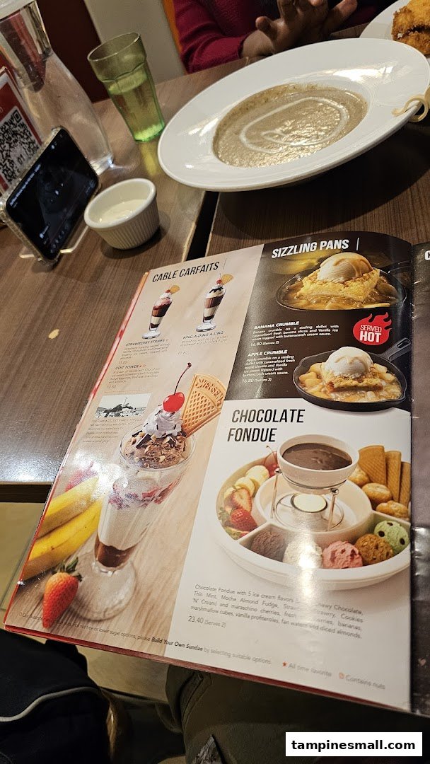 A close-up of Swensen's dessert menu featuring sundaes, sizzling pans, and chocolate fondue.