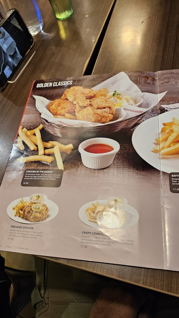 A close-up of Swensen's menu, showcasing their 'Golden Classics' fried chicken and other main dishes.