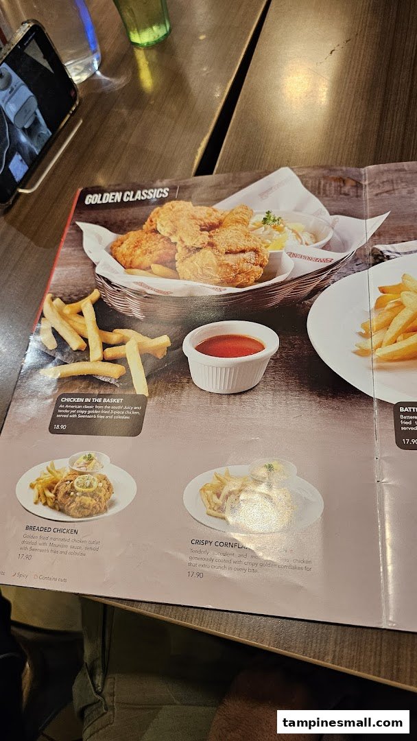 A close-up of Swensen's menu, showcasing their 'Golden Classics' fried chicken and other main dishes.