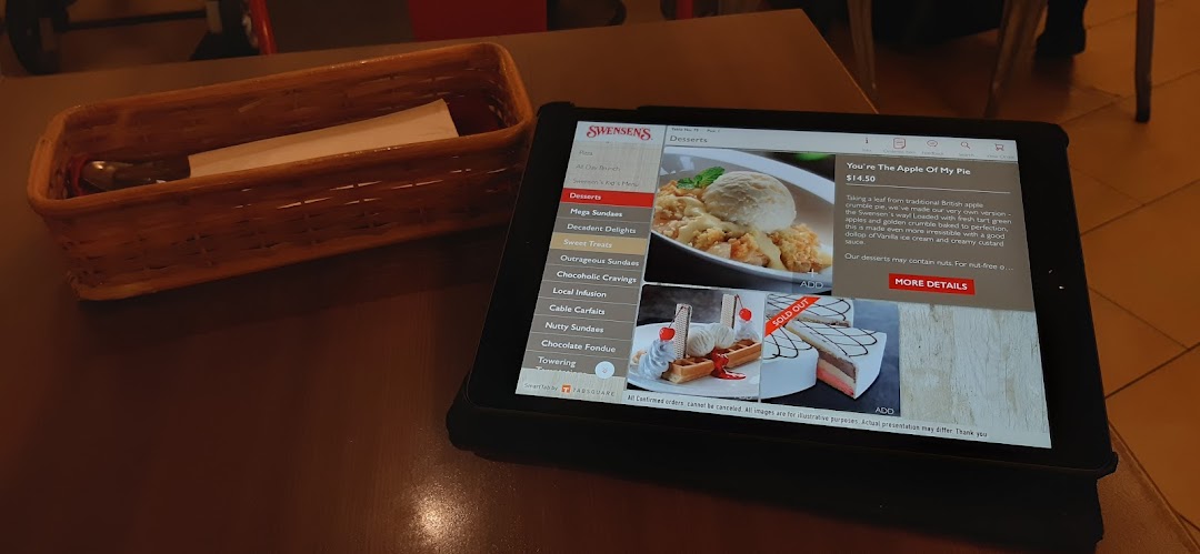 A digital menu on a tablet at Swensen's, showcasing delicious dessert options and prices.