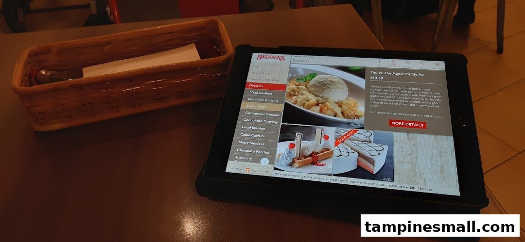 A digital menu on a tablet at Swensen's, showcasing delicious dessert options and prices.