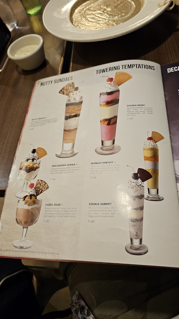 A Swensen's menu page showcasing delicious ice cream sundaes and towering desserts with descriptions and prices.
