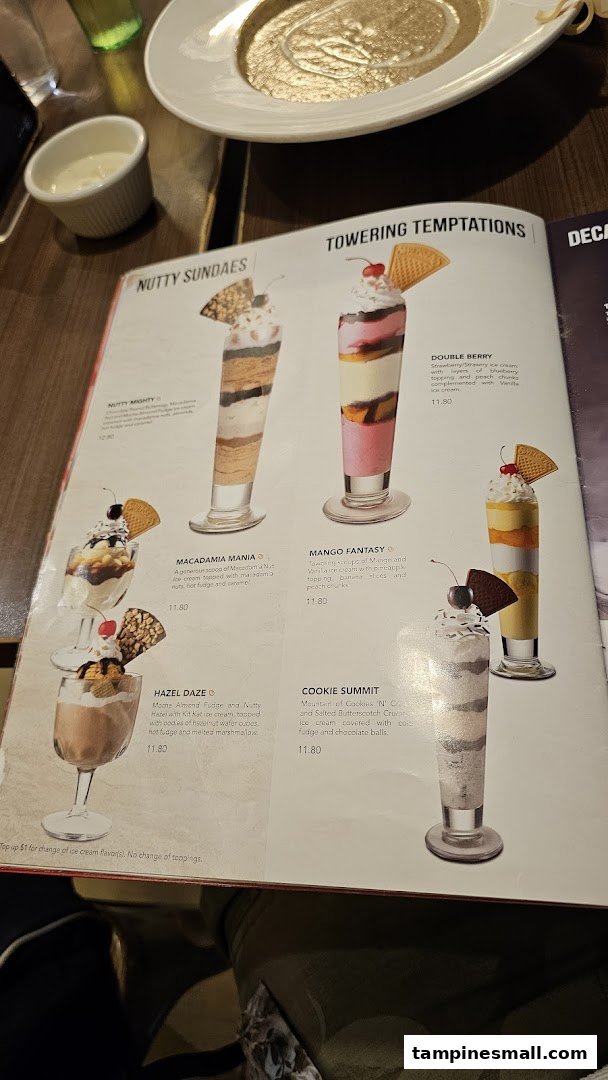 A Swensen's menu page showcasing delicious ice cream sundaes and towering desserts with descriptions and prices.