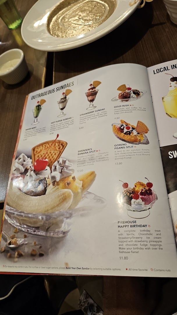 A close-up of Swensen's dessert menu, showcasing various sundaes and banana splits.