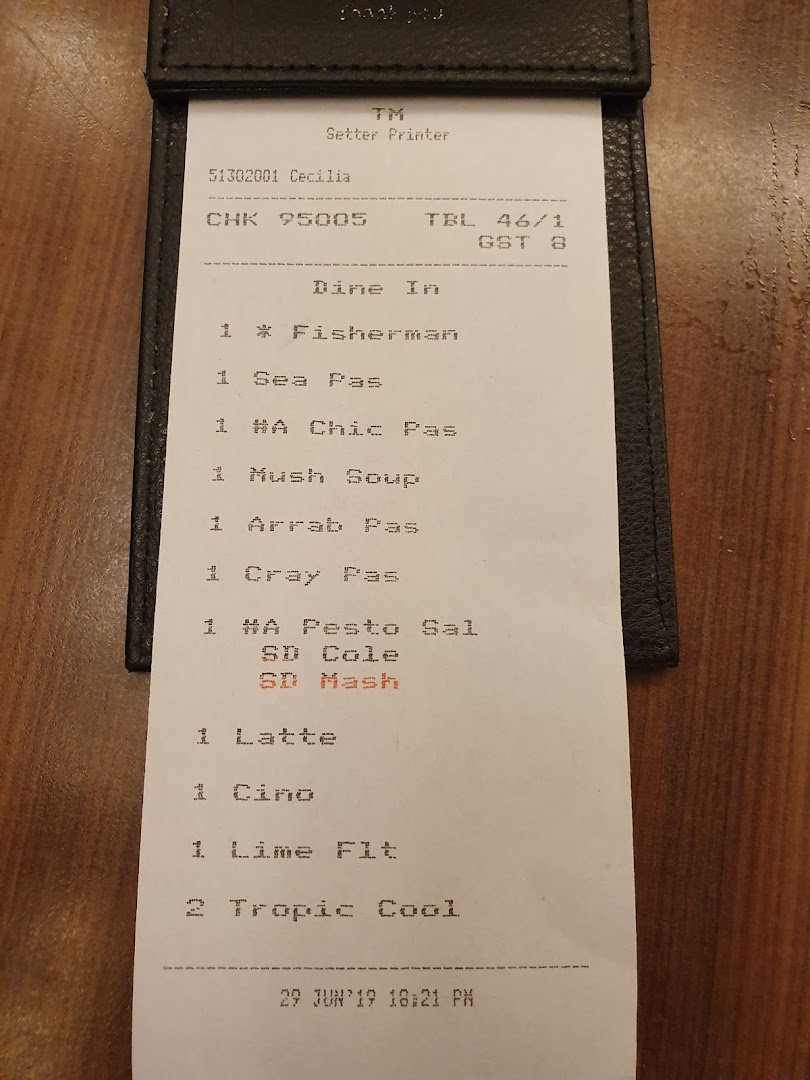 A close-up of a restaurant order slip detailing various food and beverage items.