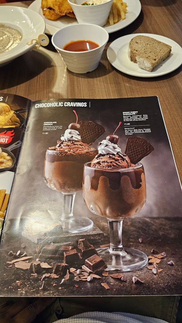 A Swensen's menu page showcasing 'Chocoholic Cravings' desserts, with other dishes visible in the background.