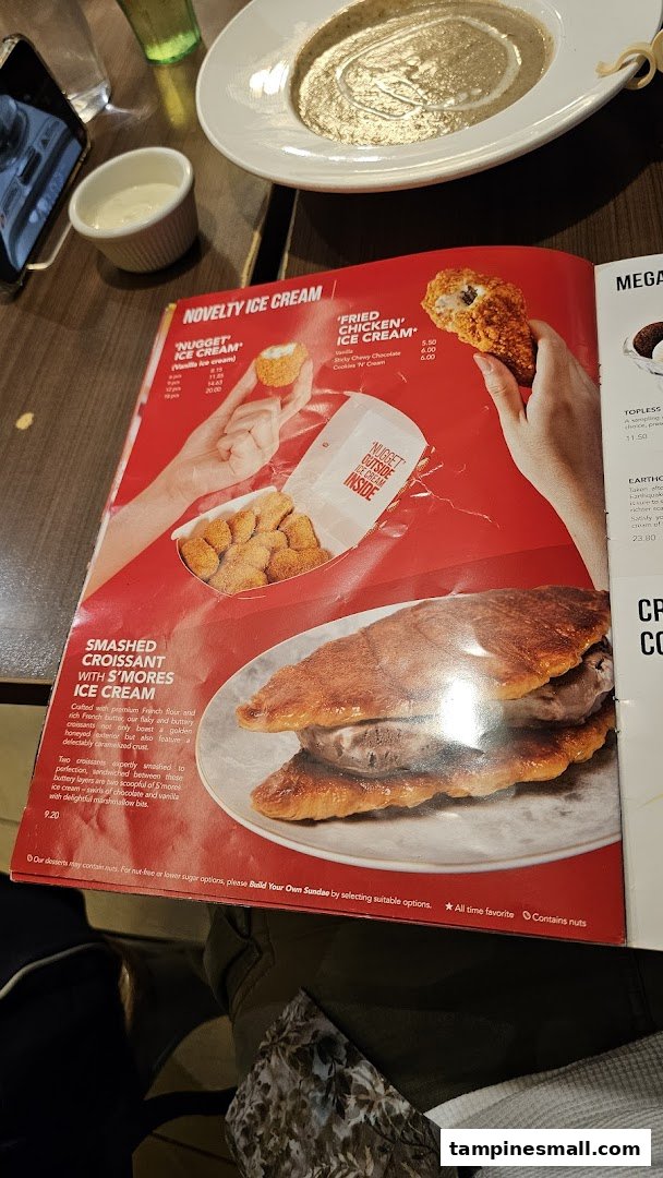 A close-up of Swensen's menu featuring novelty ice cream desserts and a croissant with s'mores ice cream.