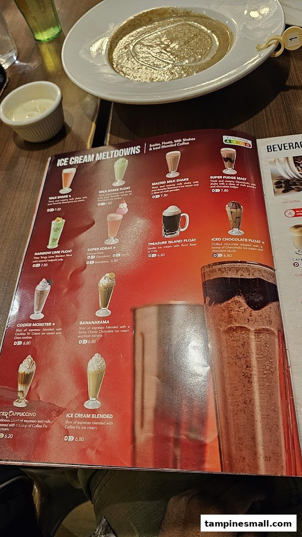 A close-up of Swensen's menu featuring ice cream meltdowns and beverages, with food on the table.