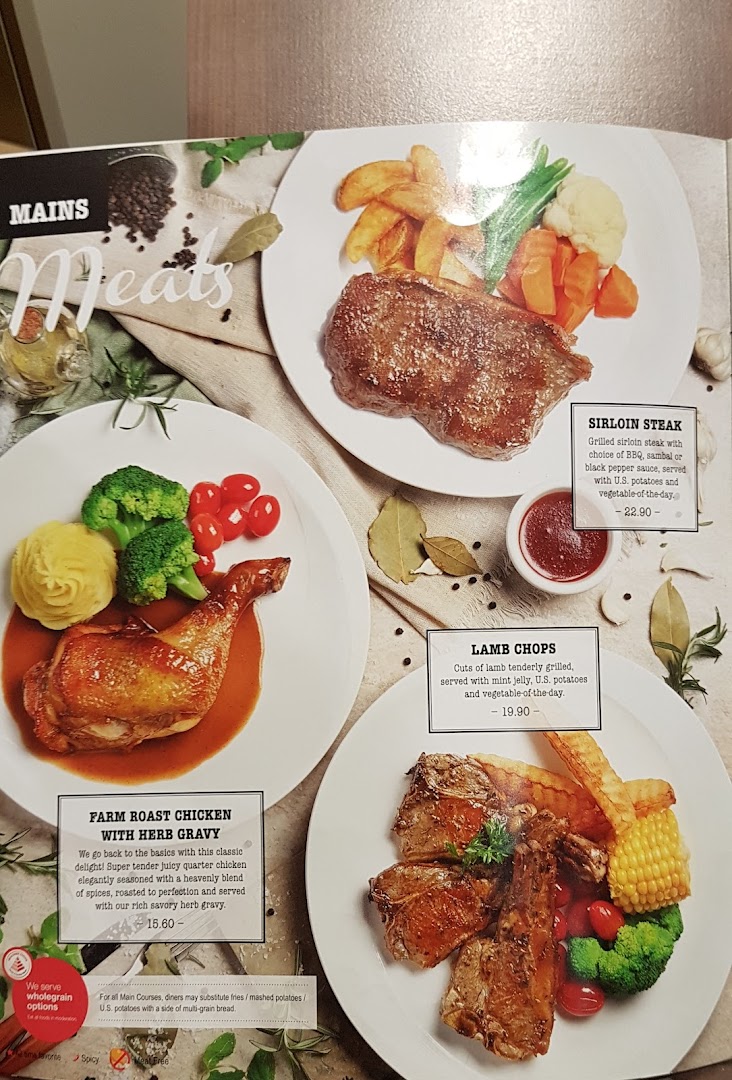 A menu page from Swensen's showcasing hearty meat main courses like steak, roast chicken, and lamb chops.