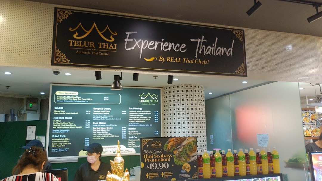 An interior shot of Telur Thai, showcasing its menu board, counter, and authentic Thai offerings.