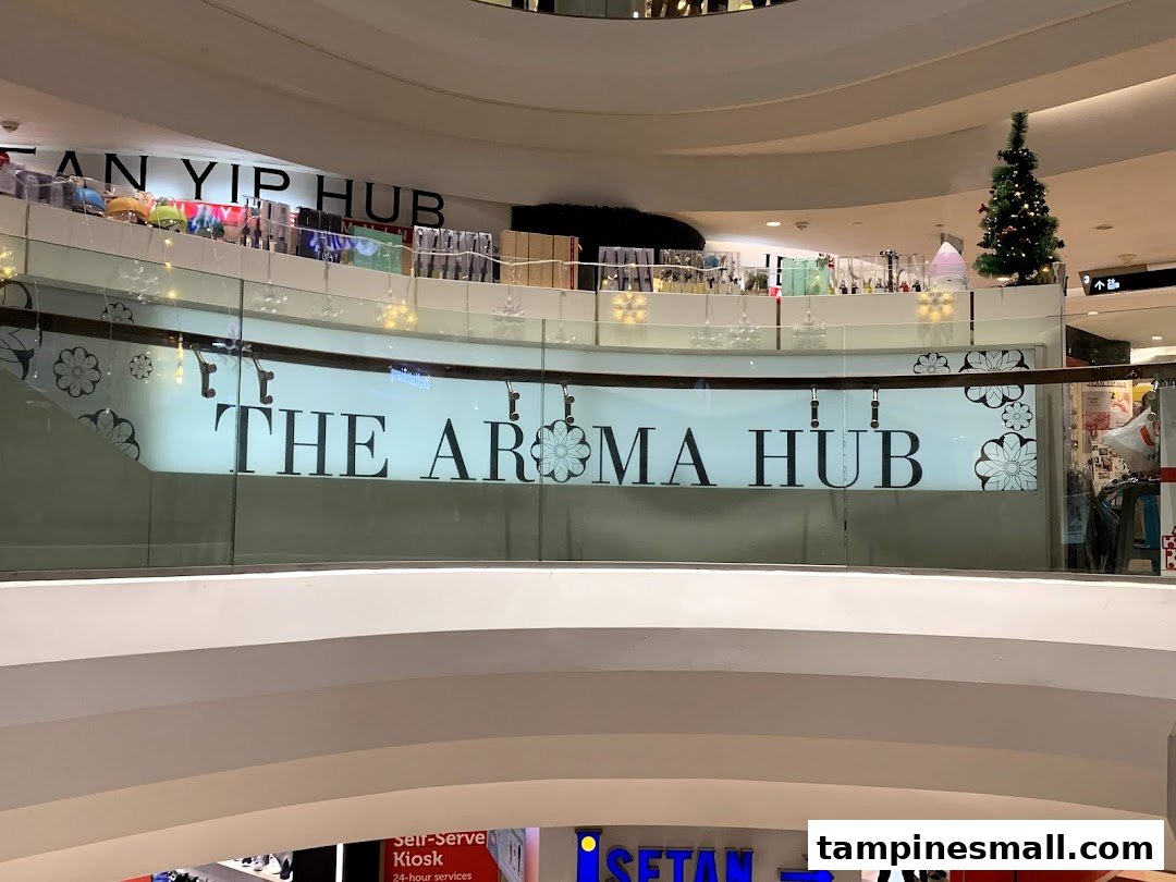 View of 'The Aroma Hub' shop signage and display from a mall atrium.