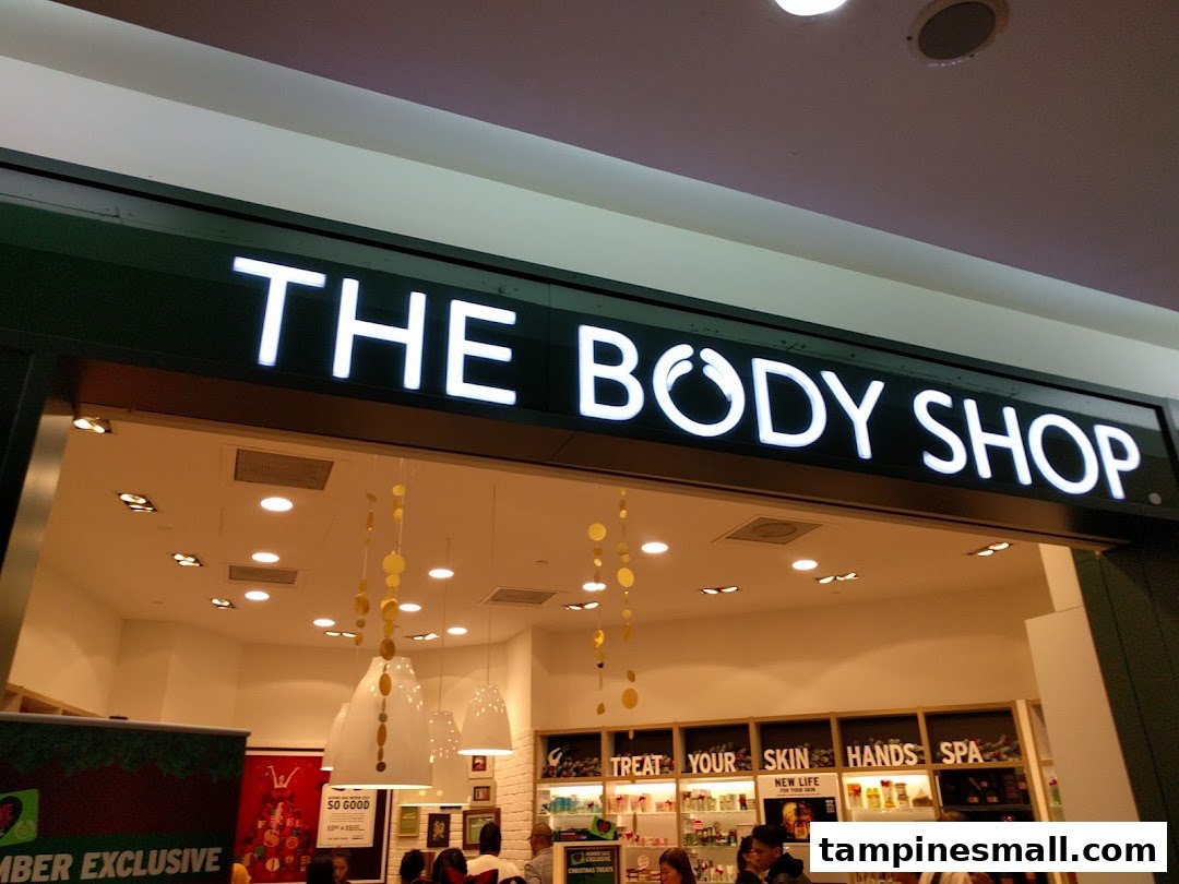 The illuminated storefront of The Body Shop, showcasing its inviting entrance and product displays.