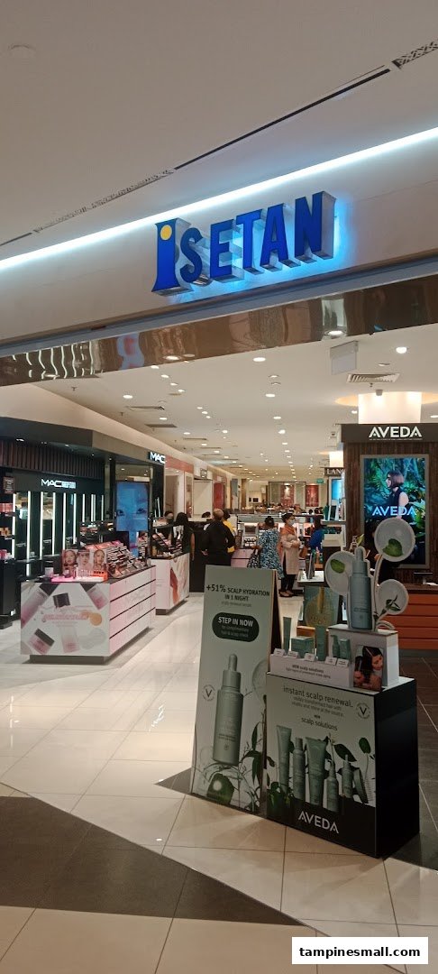 View of the ISETAN department store entrance featuring beauty counters like MAC and Aveda.