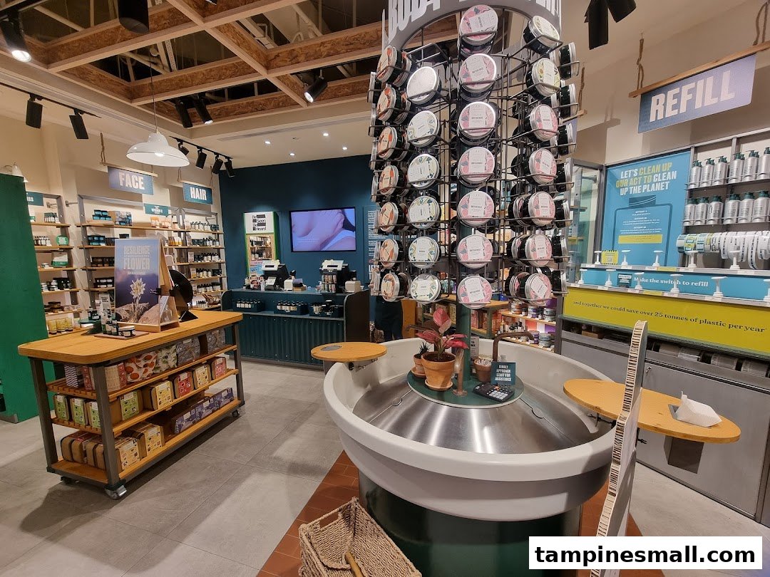 An inviting interior view of The Body Shop, showcasing beauty products and a prominent refill station.