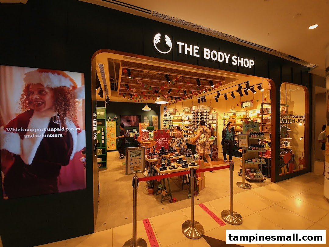 The Body Shop entrance featuring festive decorations, products, and a digital display promoting social causes.
