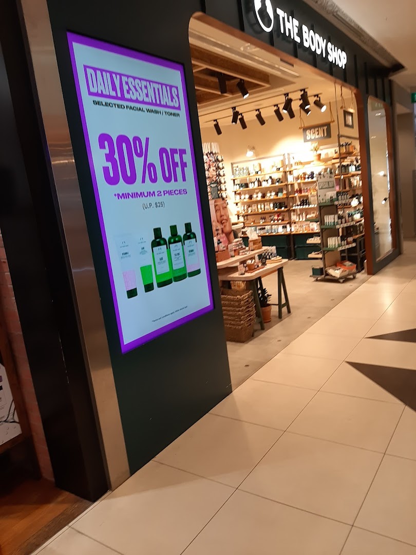 The Body Shop entrance features a prominent digital display advertising 30% off daily essentials.