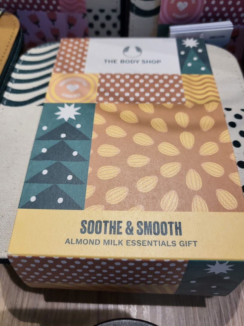 A Body Shop 'Soothe & Smooth Almond Milk Essentials Gift' box, featuring a colorful design.