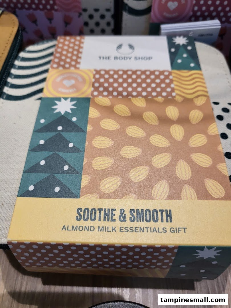 A Body Shop 'Soothe & Smooth Almond Milk Essentials Gift' box, featuring a colorful design.