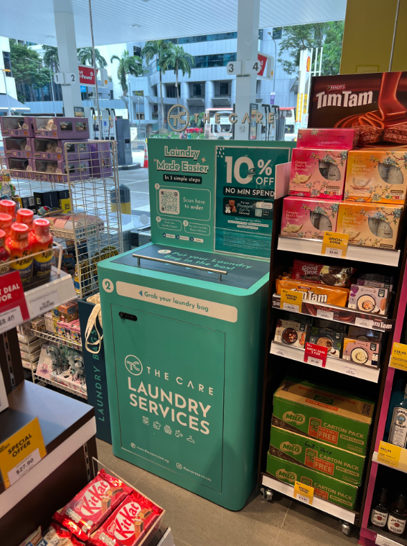A self-service laundry drop-off kiosk from The Care Laundry Services, located within a retail store.