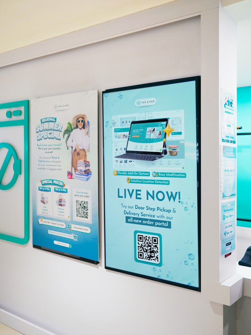 Promotional displays inside The Care Laundry, highlighting seasonal specials and new online services.