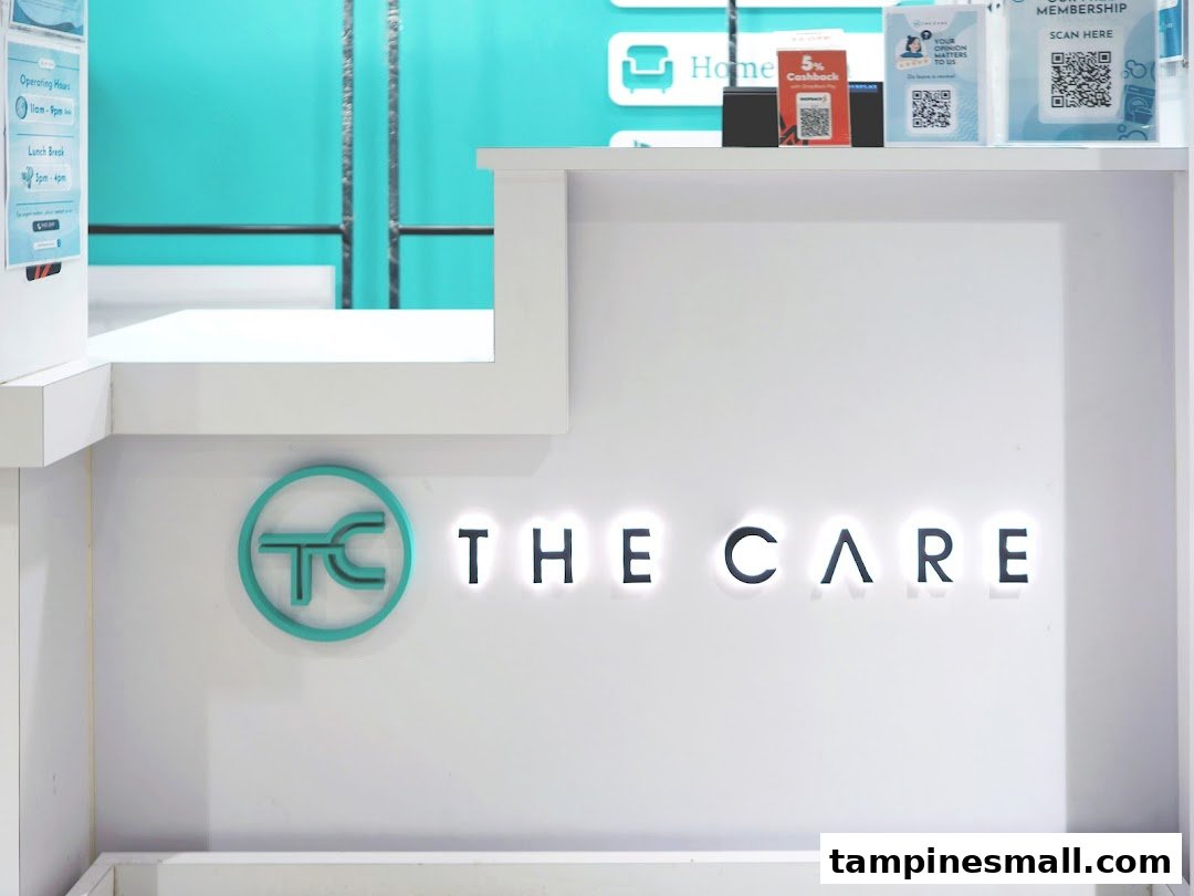 A modern reception counter featuring the illuminated 'THE CARE' logo and branding elements.