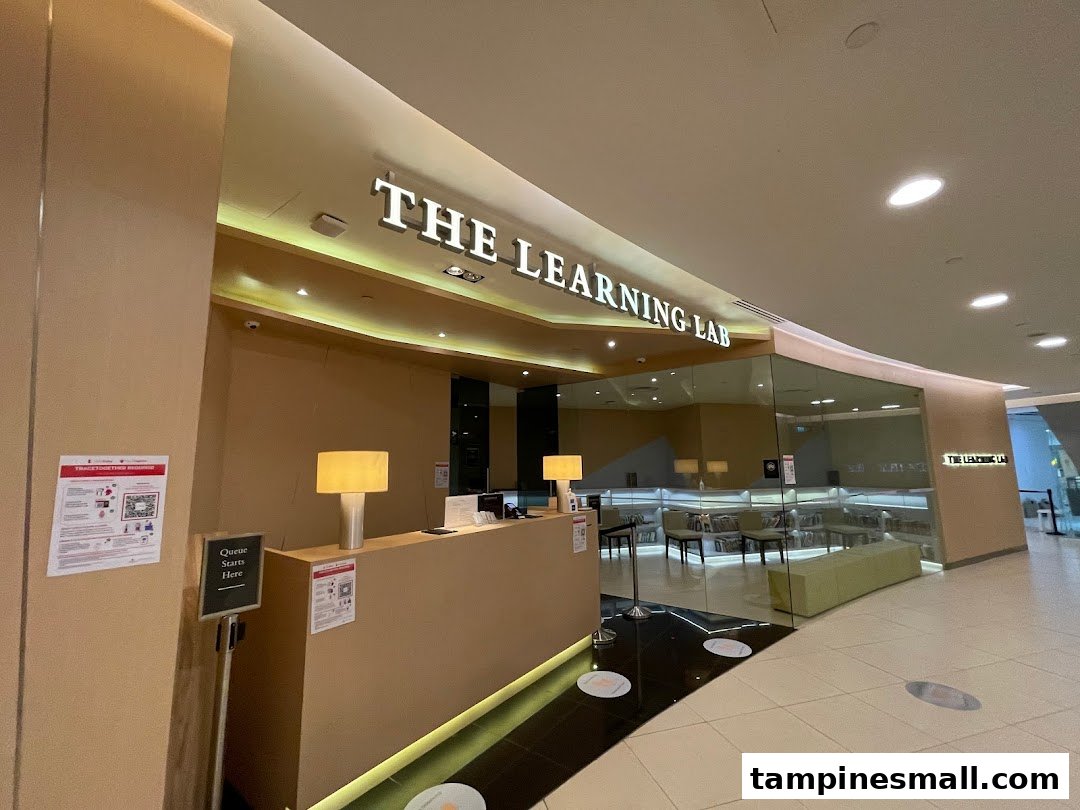 The modern entrance of The Learning Lab at Tampines Mall, featuring a reception desk and glass-fronted interior.