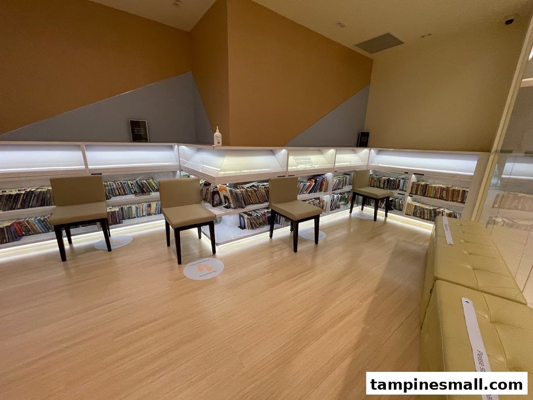 An interior view of a quiet waiting or reading area with bookshelves and comfortable seating.