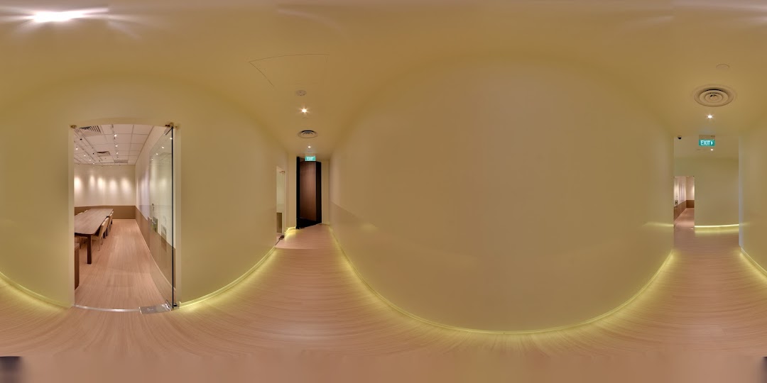 A bright, modern interior hallway of The Learning Lab with visible classrooms and warm lighting.